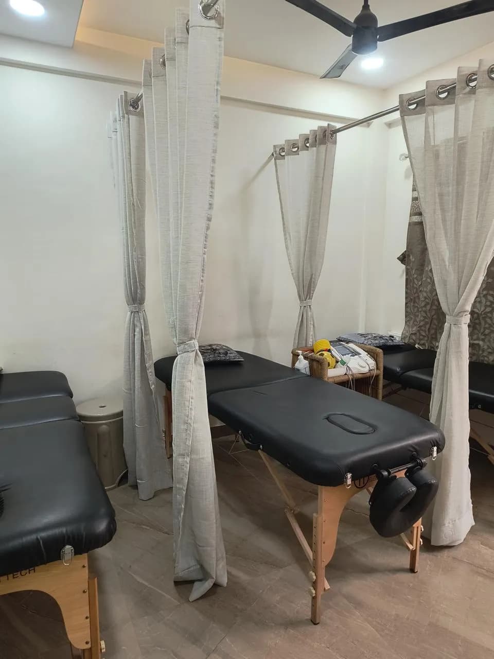 Physiotherapy treatment room with curtained therapy beds