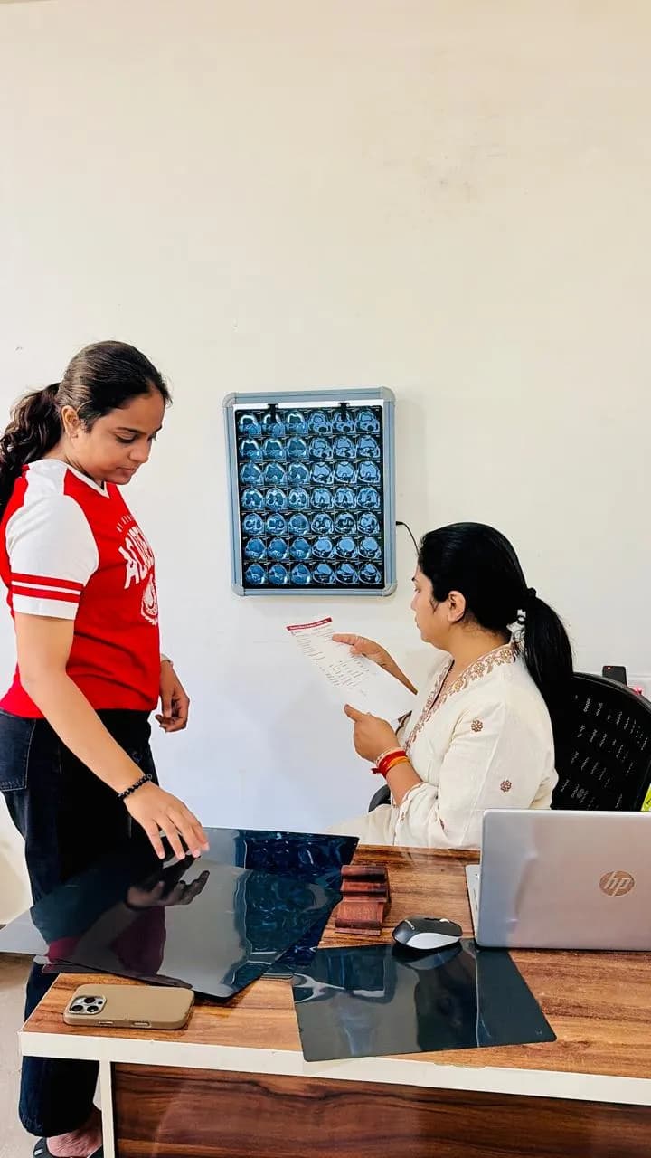 Physiotherapist reviewing a patient's imaging during assessment