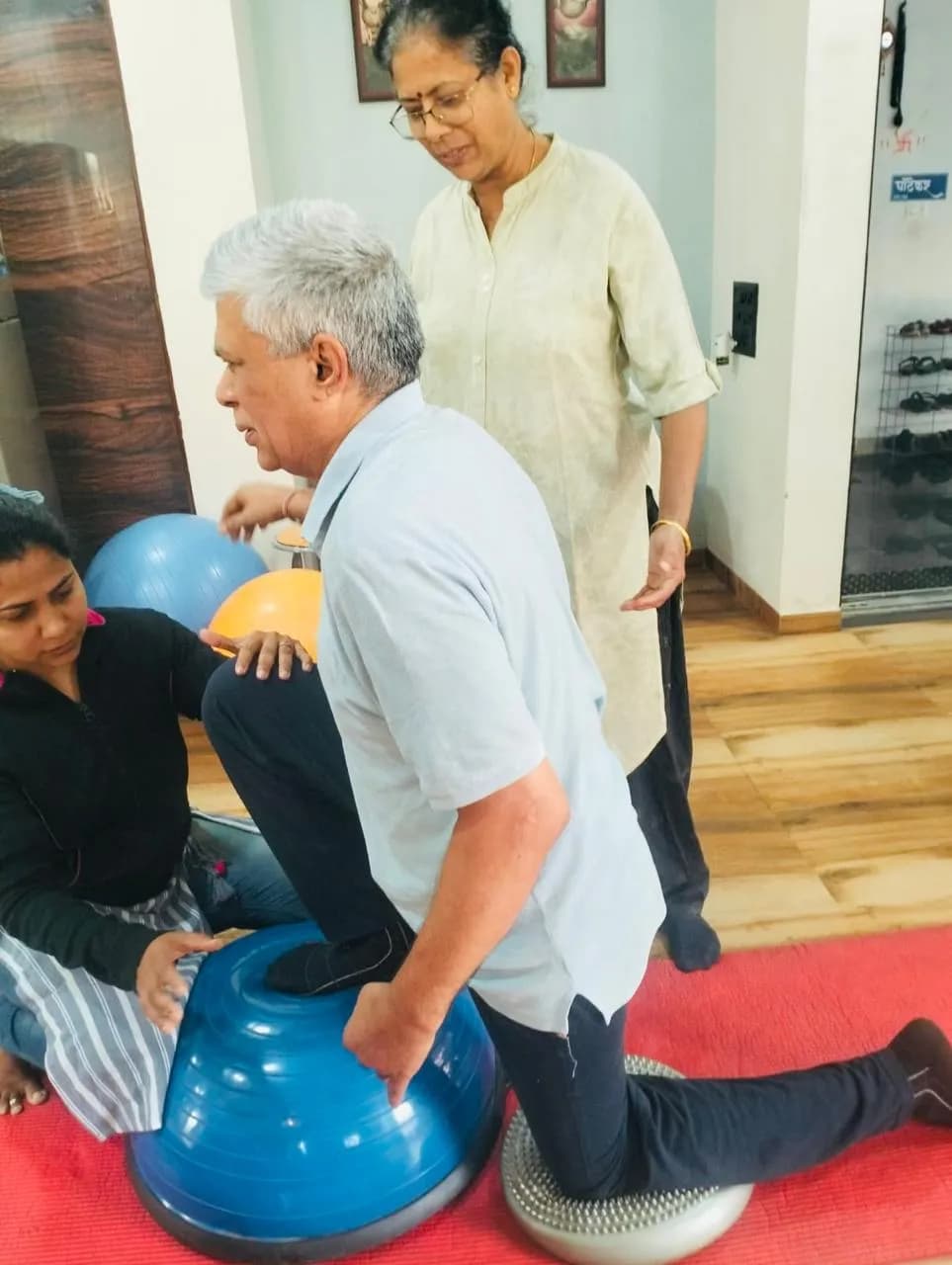 Physiotherapist supervising balance and stability training with a patient
