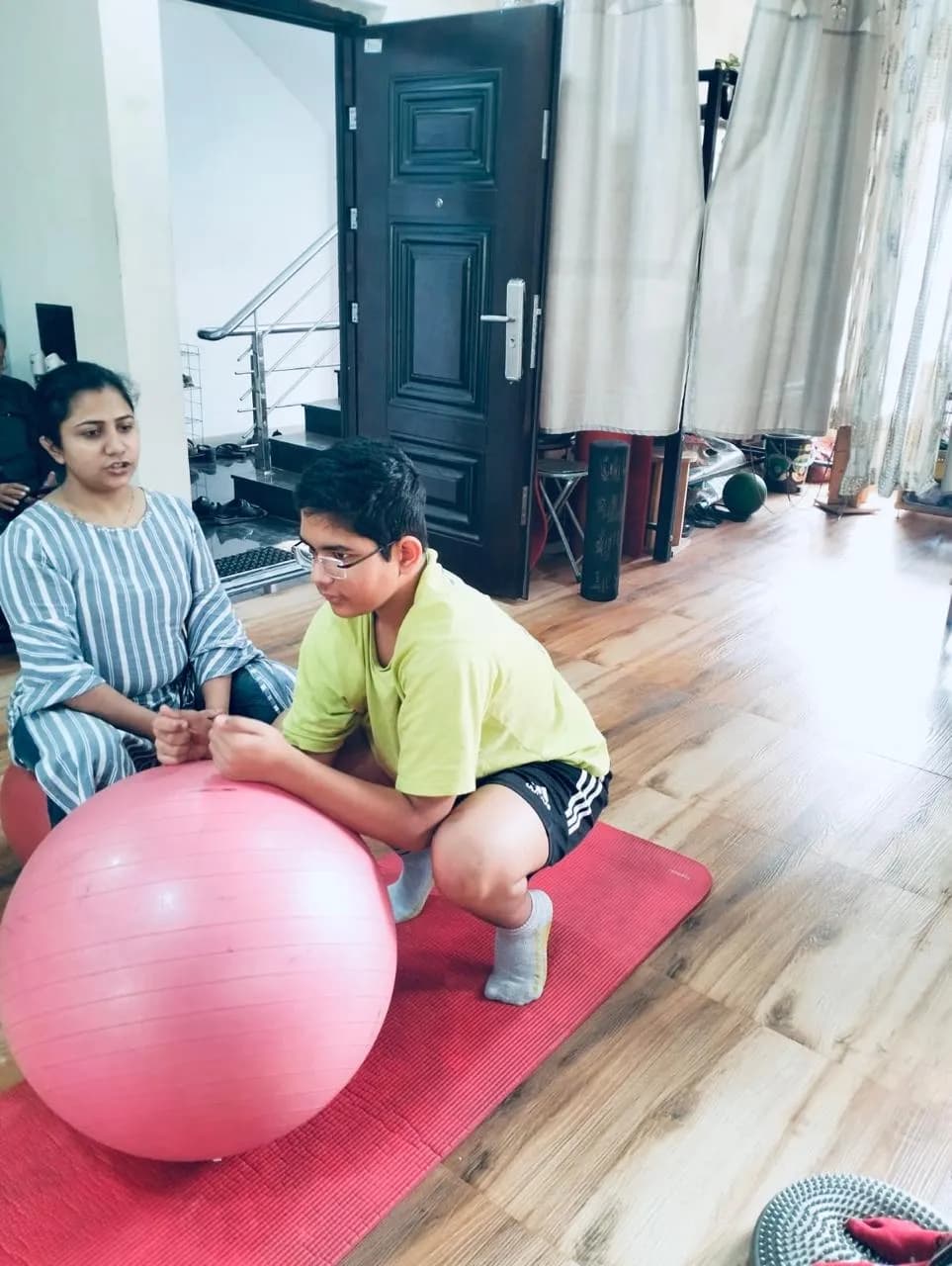 Pediatric physiotherapy session with a stability ball