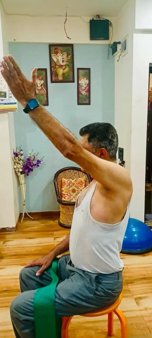 Seated mobility and shoulder exercise for an older patient
